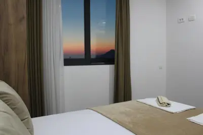 a hotel room with a bed and a window at AMD - stan 314 in Dobra Voda