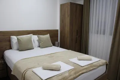 a bedroom with a bed with two towels on it at AMD - stan 314 in Dobra Voda