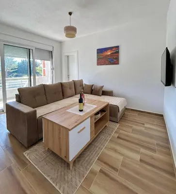 a living room with a couch and a table at Apartman Živaljević 3 Tivat in Tivat
