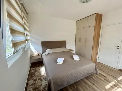 a bedroom with a bed with two towels on it at Apartman Živaljević 3 Tivat in Tivat