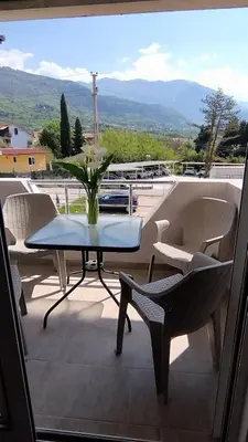 a table and chairs on a balcony with a view at Apartman Živaljević 3 Tivat in Tivat