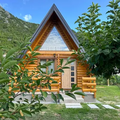 a log cabin with a large window on it at Valley Nest in Virpazar