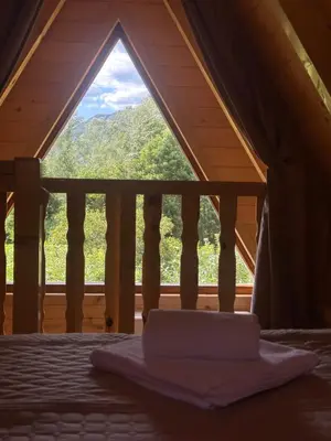 a laptop sitting on a bed in front of a window at Valley Nest in Virpazar
