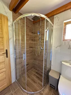a shower with a glass door in a bathroom at Valley Nest in Virpazar