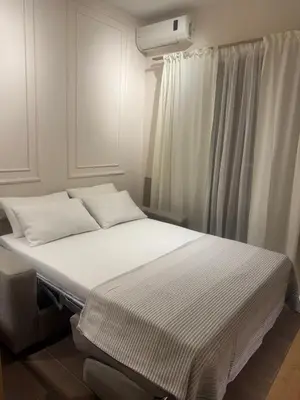 a bed with white sheets and pillows in a room at Studio Apartman Stefana in Kravlja