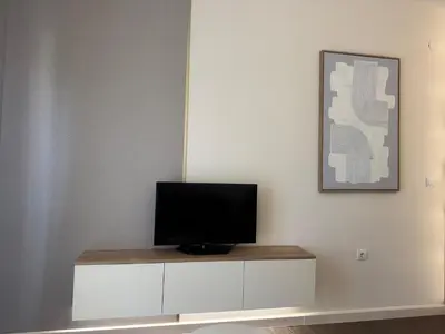 a television sitting on top of a white cabinet at Studio Apartman Stefana in Kravlja