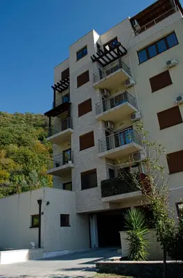 a tall building with balconies on the side of it at Studio Apartman Stefana in Kravlja