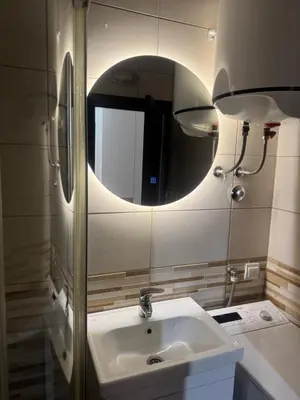 a bathroom with a sink and a mirror at Studio Apartman Stefana in Kravlja