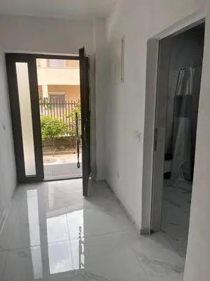 an empty hallway with a door open to a courtyard at BarDeluxe in Bar