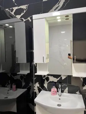 a bathroom with a white sink and a mirror at BarDeluxe in Bar