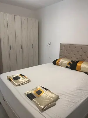a bedroom with a bed with two bags on it at BarDeluxe in Bar