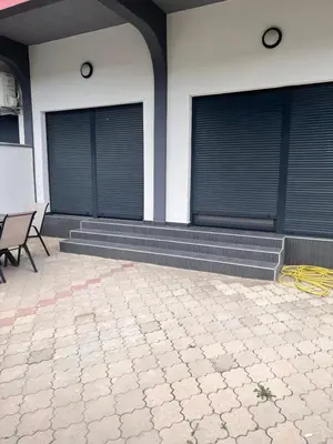 a building with two windows with blinds on it at BarDeluxe in Bar