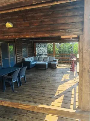 a wooden deck with couches and chairs on it at River Escape Ada Bojana in Ulcinj