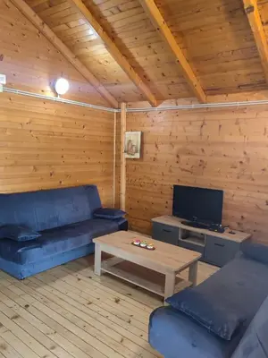a living room with a blue couch and a coffee table at River Escape Ada Bojana in Ulcinj