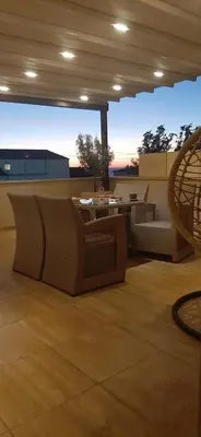 a living room with a couch and a table at Apartman Staša in Kravlja
