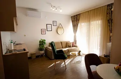 a living room with a couch and a table at Apartman Staša in Kravlja