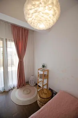 a living room with a large light hanging from the ceiling at Apartman Staša in Kravlja