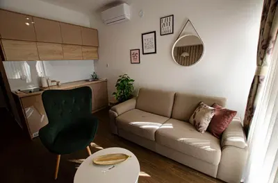 a living room with a couch and a table at Apartman Staša in Kravlja