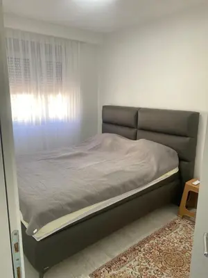 a bed in a small room with a window at Apartmani Hasanovic in Bar