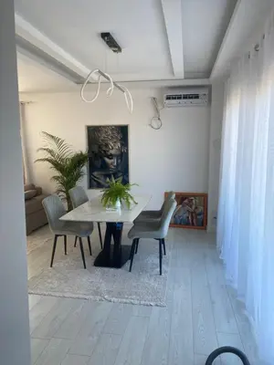 a dining room with a table and chairs at Apartmani Hasanovic in Bar
