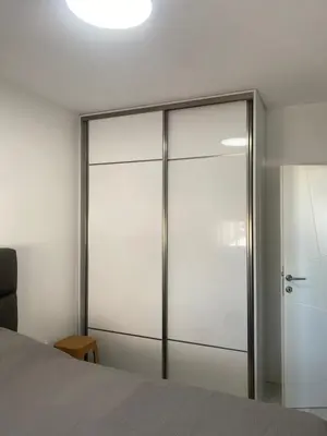 a sliding glass closet door in a bedroom at Apartmani Hasanovic in Bar
