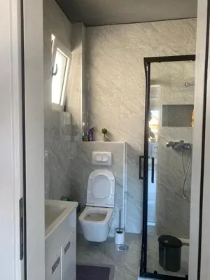 a bathroom with a toilet and a sink and a shower at Apartmani Hasanovic in Bar