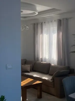 a living room with a couch and a table at Apartmani Hasanovic in Bar