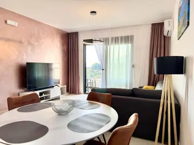 a living room with a table and a couch at Apartment BAR M3A sea view in Bar
