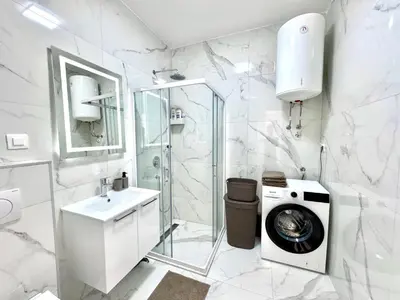 a bathroom with a washing machine and a washer at Apartment BAR M3A sea view in Bar