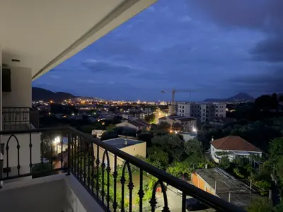 a view of a city at night from a balcony at Apartment BAR M3A sea view in Bar