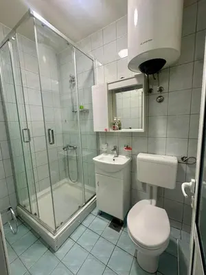a bathroom with a shower and a toilet and a sink at Antoni Apartments in Ulcinj