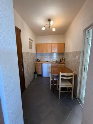 a kitchen with a table and a table and chairs at Antoni Apartments in Ulcinj