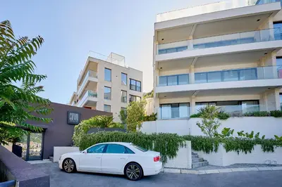 a white car parked in front of a building at Como Vista Apartments in Budva