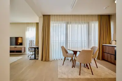 a living room with a dining room table and chairs at Como Vista Apartments in Budva