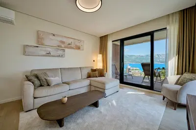 a living room with a couch and a table at Como Vista Apartments in Budva