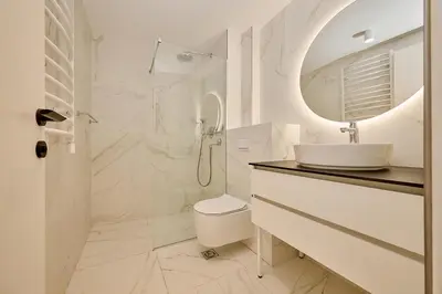 a white bathroom with a sink and a mirror at Como Vista Apartments in Budva