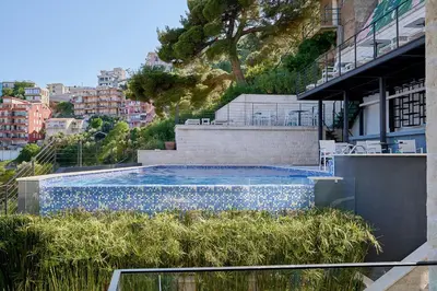 a swimming pool on the side of a building at Como Vista Apartments in Budva