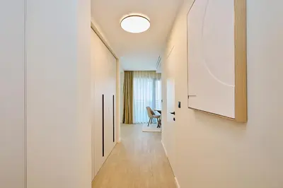 a hallway leading to a room with a ceiling at Como Vista Apartments in Budva