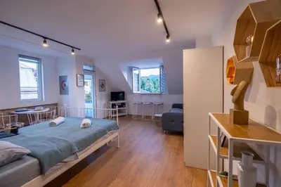 a bedroom with a bed and a living room at 086 Studio Apartment in Cetinje