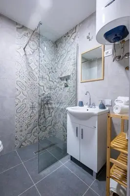 a bathroom with a shower and a sink at 086 Studio Apartment in Cetinje