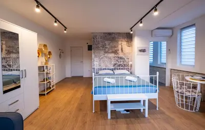 a room with a bed with a table in it at 086 Studio Apartment in Cetinje