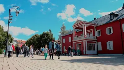 a group of people walking in front of a red building at 086 Studio Apartment in Cetinje