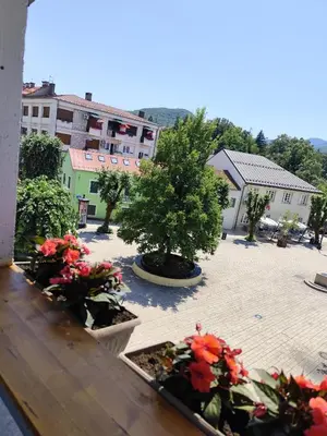 a view of a courtyard with flowers and buildings at 086 Studio Apartment in Cetinje