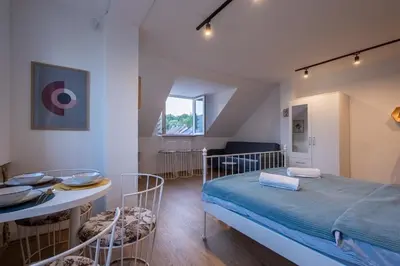 a bedroom with a bed and a table and chairs at 086 Studio Apartment in Cetinje