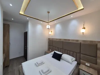 a bedroom with a bed with two pillows on it at Ajum Apartments in Ulcinj