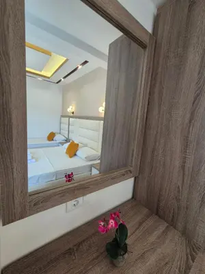 a mirror in the corner of a bedroom with a bed at Ajum Apartments in Ulcinj