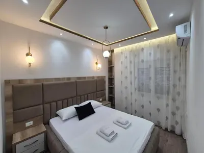 a bedroom with a bed with two towels on it at Ajum Apartments in Ulcinj