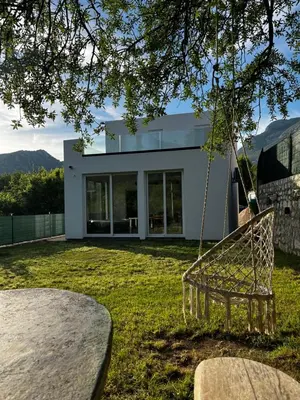 a swing in front of a house at House in Nature Milić in Čanj