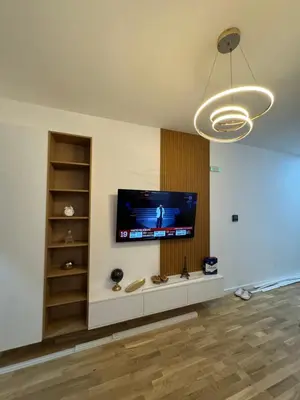 a living room with a flat screen tv on a wall at Lux stan in Bar