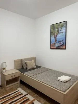a bedroom with a bed and a picture on the wall at Peony in Budva